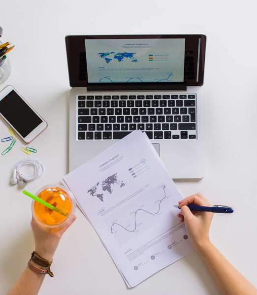 hands with laptop and papers at office table Asesoria Online